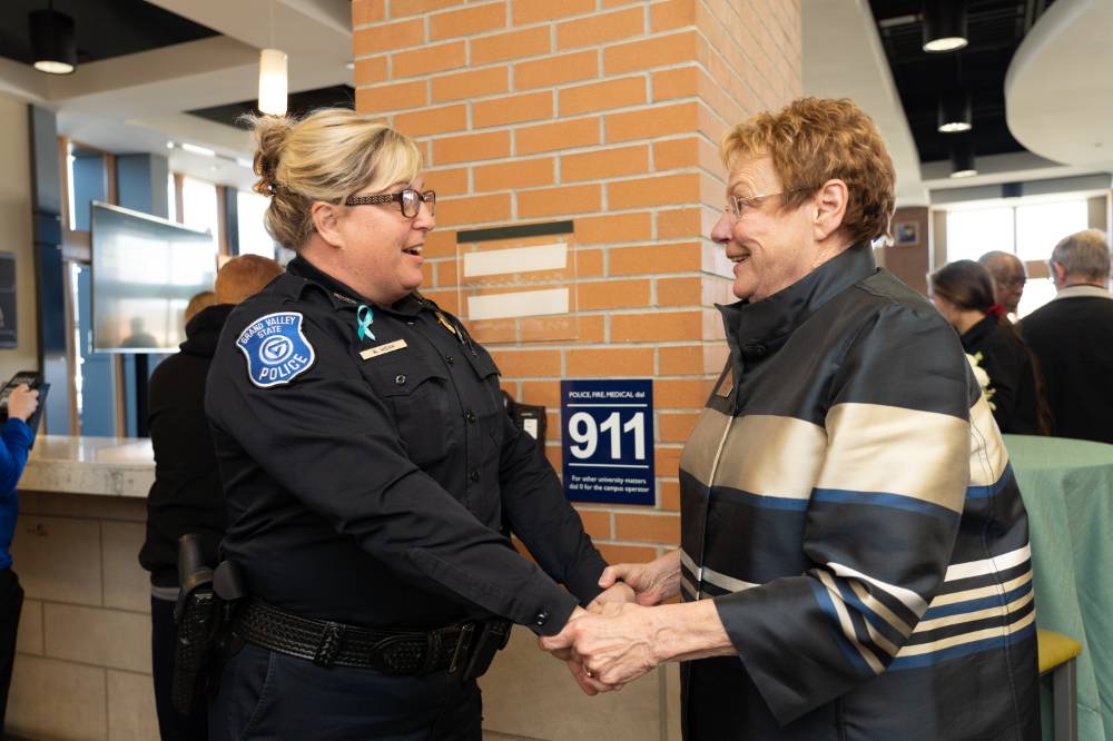 Lynn Blue greeting a GVPD officer at the Lynn M. Blue Connection Naming Ceremony